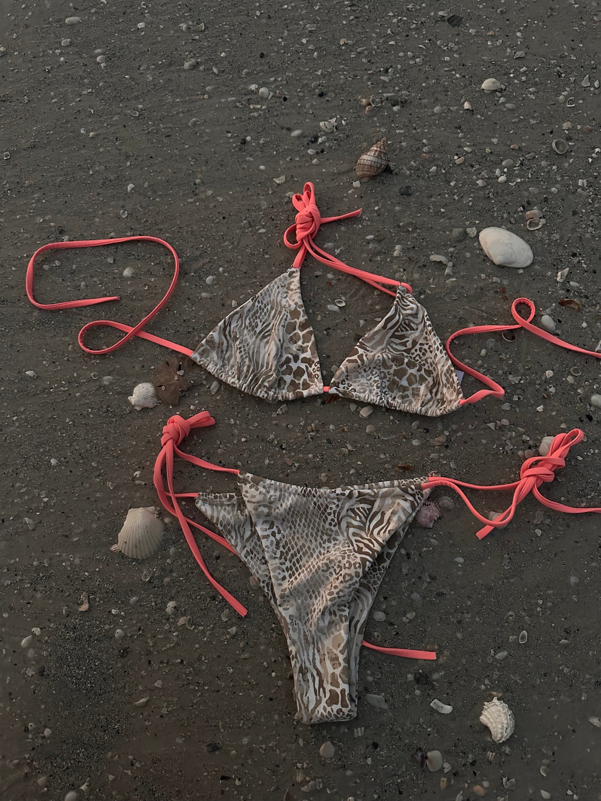 Safari inspired bikini set with pink vibrant strings on the beach
